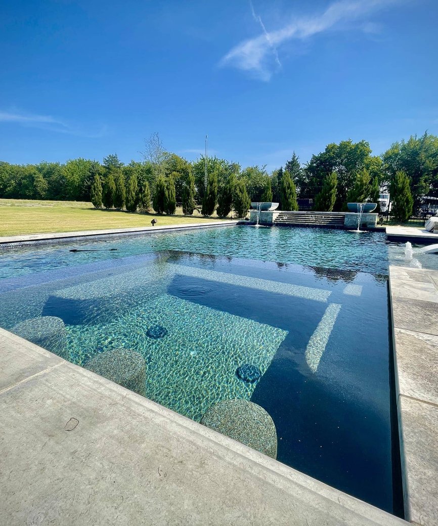 Modern geometric pool with contemporary decking and architectural features