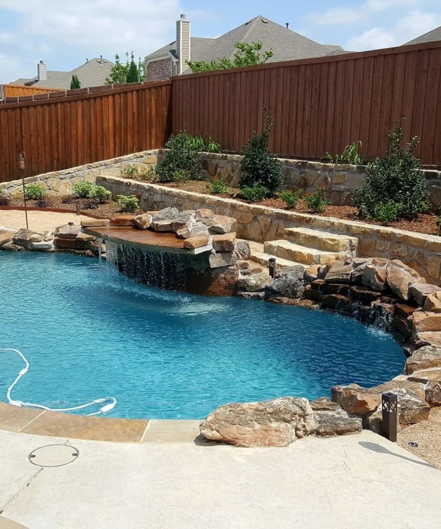 Compact small pool with integrated spa and tanning ledge in small backyard